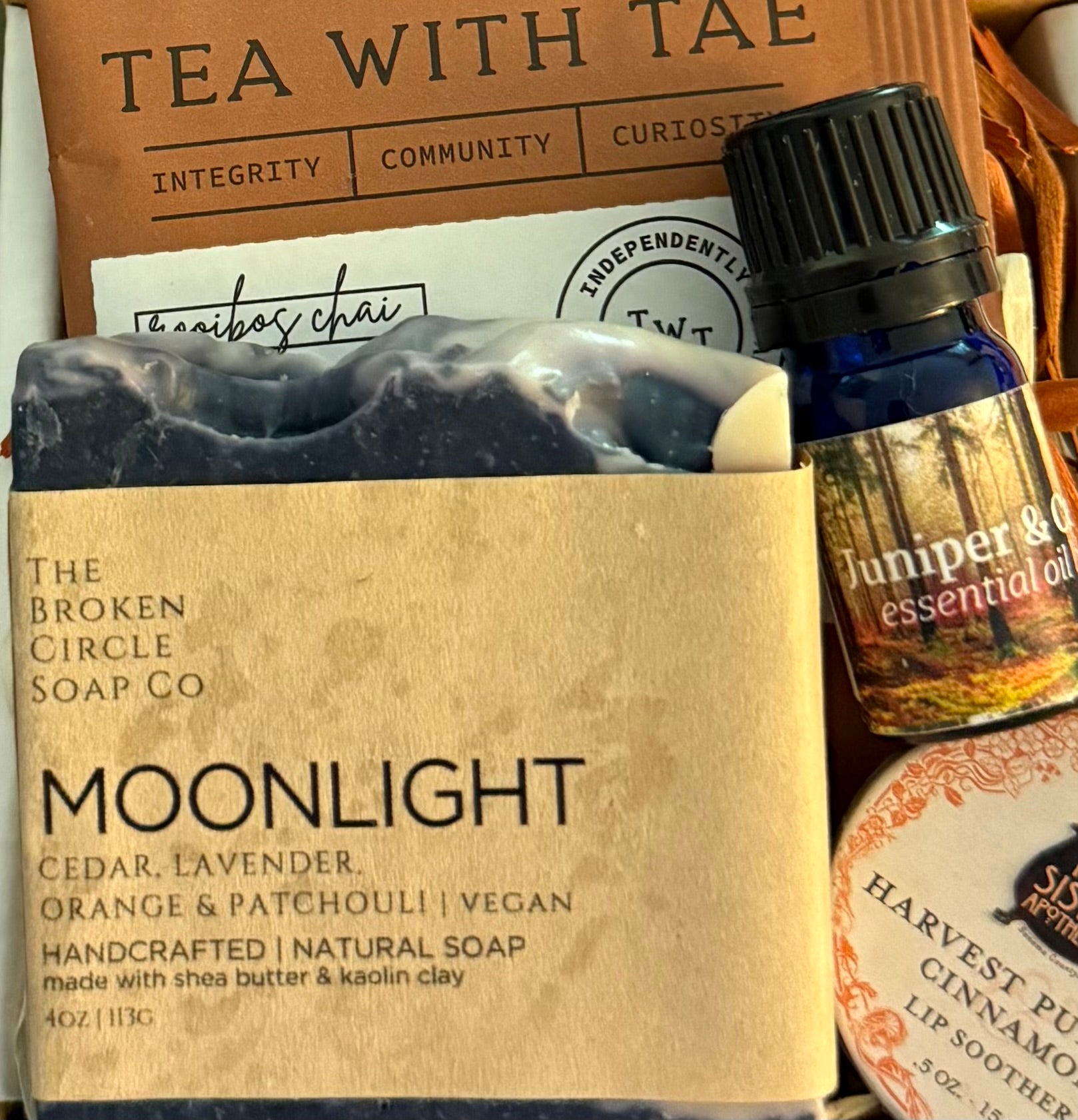 Moonlight soap bar from The Broken Circle Soap Co with Juniper & Cedar essential oil bottle in the background.